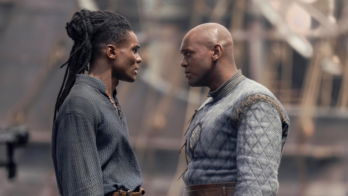 Clinton Liberty and Abubakar Salim as Addam and Alyn of Hull on House of the Dragon standing in profile looking at one another near a dock