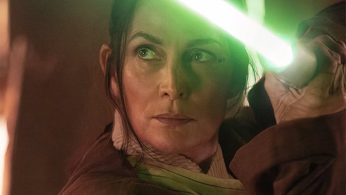 Carrie-Anne Moss holding her green Jedi lightsaber on The Acolyte