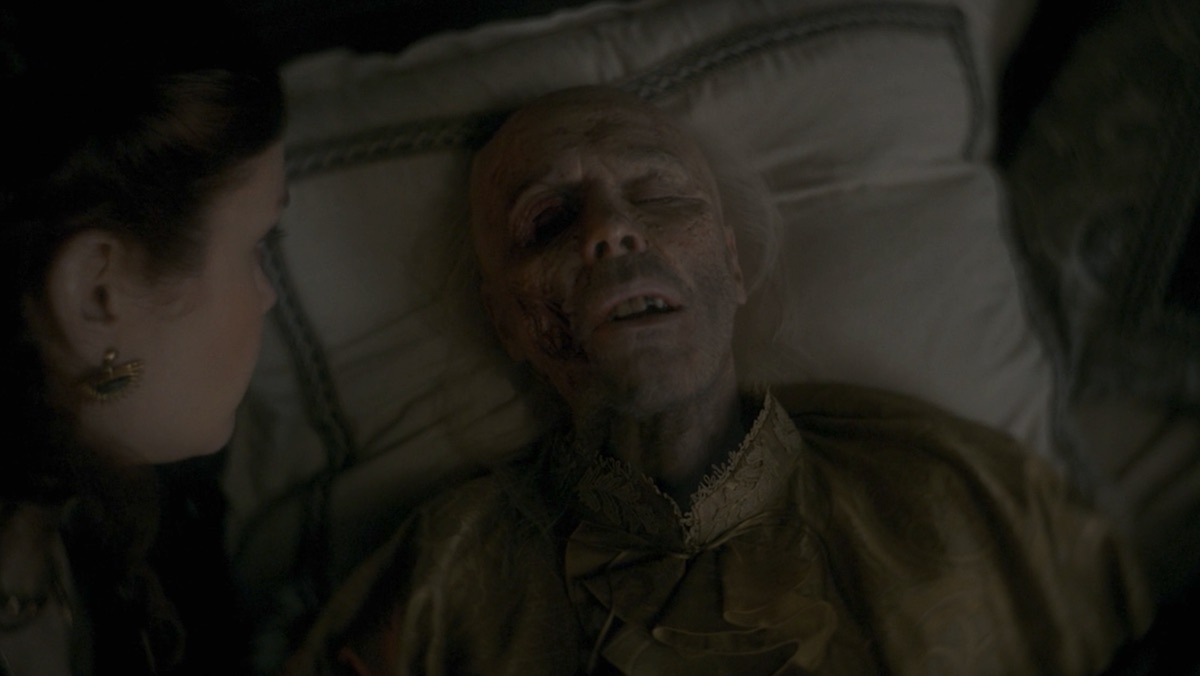 A dying King Viserys in bed talking to his wife Alicent on House of the Dragon