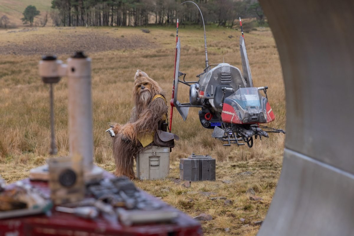 kelnacca sits as a drone flies near him