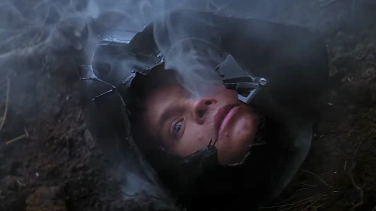 Luke Skwalker's face sticking out of Vader's destroyed smoking helmet in The Empire Strikes Back