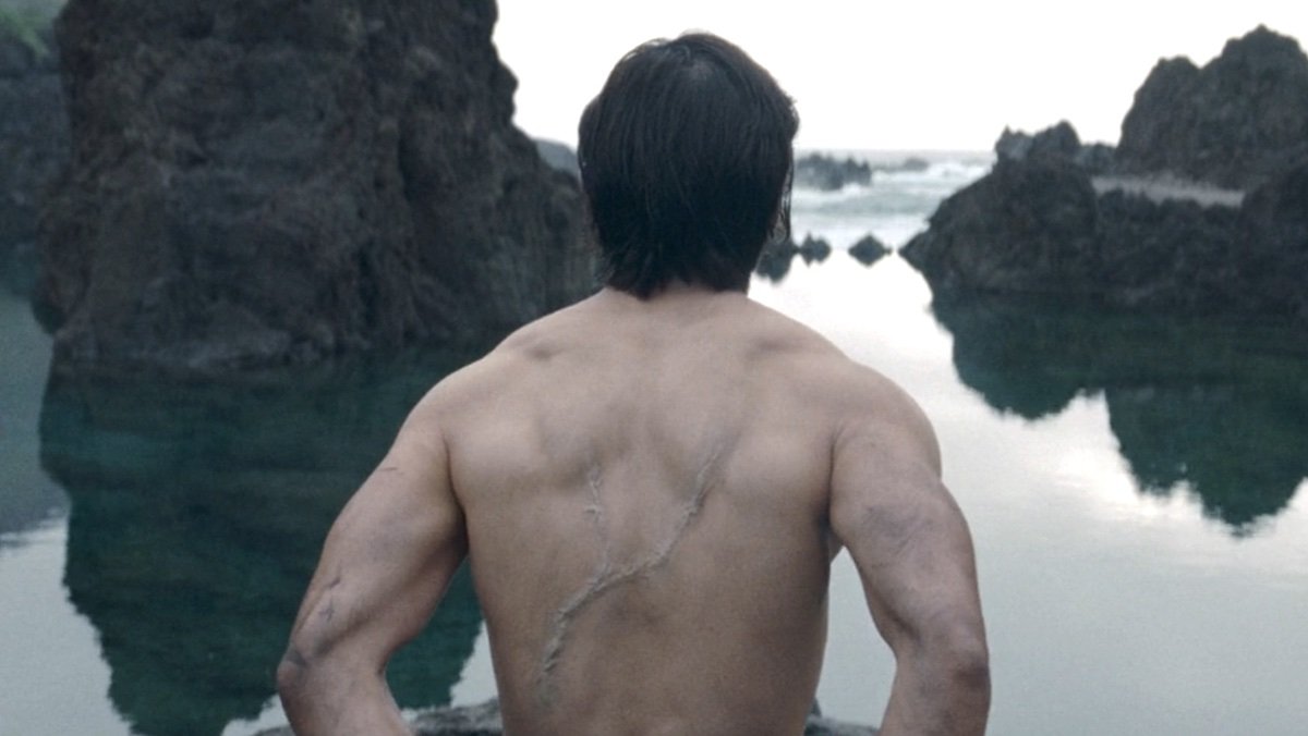 A naked Qimir from behind with his large scar on display on The Acolyte