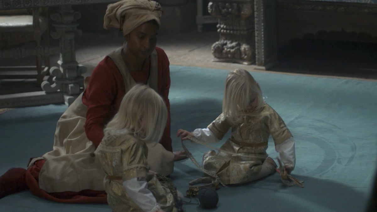 A nursemaid plays with Halaena and Aegon's twins, Jaehaerys and Jaehaera on House of the Dragon